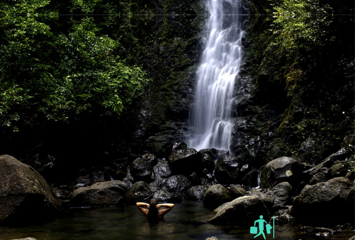 Woman enjoying swim in Lulumahu Falls